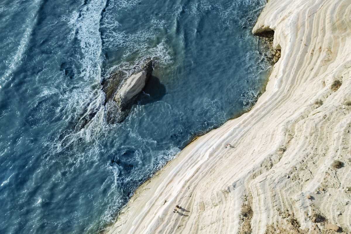 Panoramica dall’alto della Balata dei Turchi con il mare turchese, la scogliera e la vegetazione mediterranea di Pantelleria. Atmosfera estiva e rilassata.